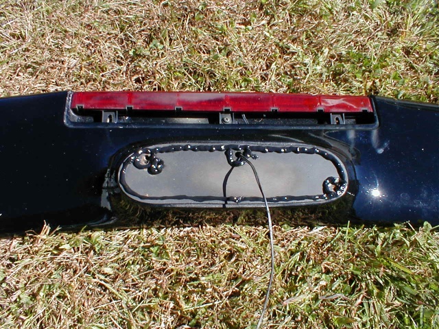... peeled up the gaskets...
(remember that paint scuff on the trunk lid? Interesting, it matches the big scuff on the bottom of the brake light here... I tightened that up. It won't be falling out and scratching up the car anymore!)