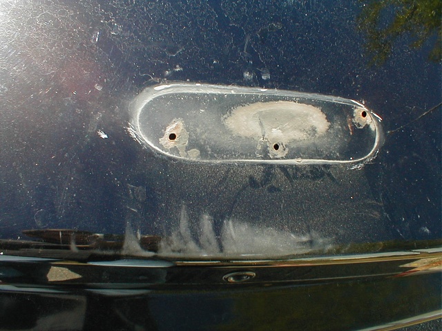 The gaskets under the spoiler had slid out to the sides, were leaking, and making my trunk space oh so stinky... not to mention the big rust that is forming under there... (note the big, wide scuff in the paint above the keyhole in the trunk. see it?)